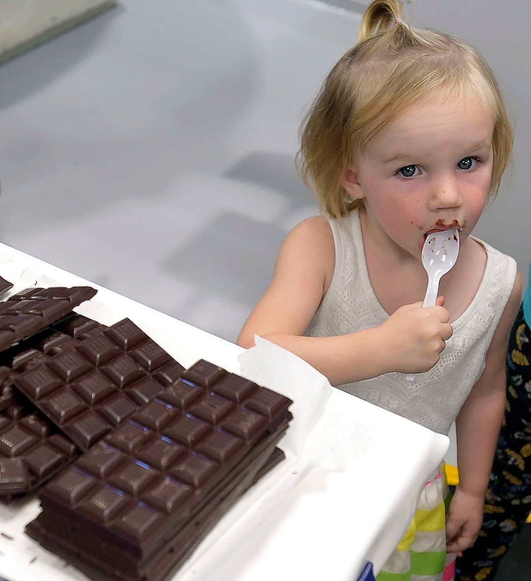 (Eli Lucero  |  The Herald Journal) Quinn Esplin has a taste of dark chocolate during a public tour of the Aggie Chocolate Factory on Tuesday in Logan.
