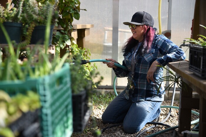 (Francisco Kjolseth  |  The Salt Lake Tribune)  Jenn Harris, a former recovery resident at the Center for Women and Children in Murray, loves volunteering her time now at the Freedom Garden across the street from the center, where residents can learn how to grow fruits and vegetables and make strides towards rehabilitation. The garden has been a place of healing and also acts as a memorial for those who have passed in their battle with substance abuse with stones bearing their names in the garden. 