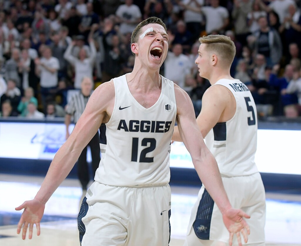 (Eli Lucero  |  The Herald Journal via AP)  Utah State forward Justin Bean (12) celebrates after drawing a charge in the final minute against Nevada during an NCAA college basketball game Saturday, March 2, 2019, in Logan, Utah. 