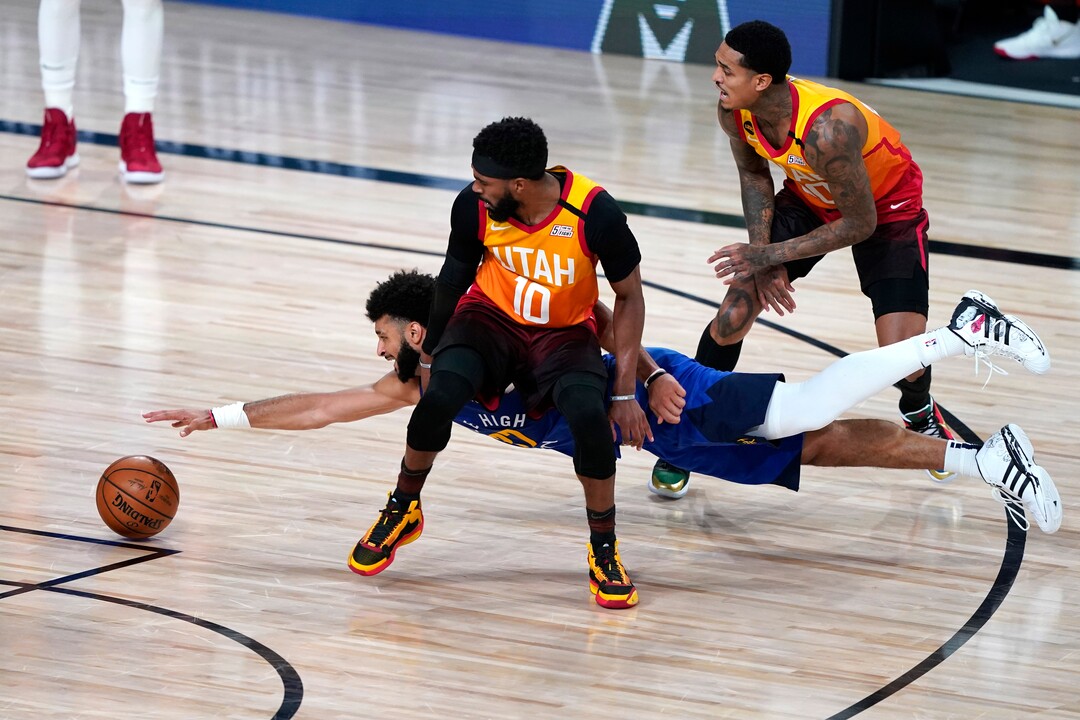 Denver Nuggets' Jamal Murray (27) dives for a loose ball behind Utah Jazz's Mike Conley (10) during the second half of an NBA basketball first round playoff game Sunday, Aug. 30, 2020, in Lake Buena Vista, Fla. The Nuggets won 119-107. (AP Photo/Ashley Landis)