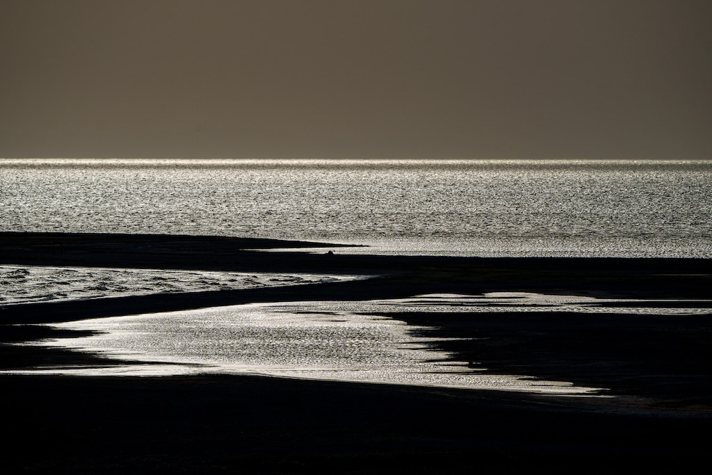 (Trent Nelson | The Salt Lake Tribune) Dust blows over the Great Salt Lake and Antelope Island on Monday, May 12, 2025.