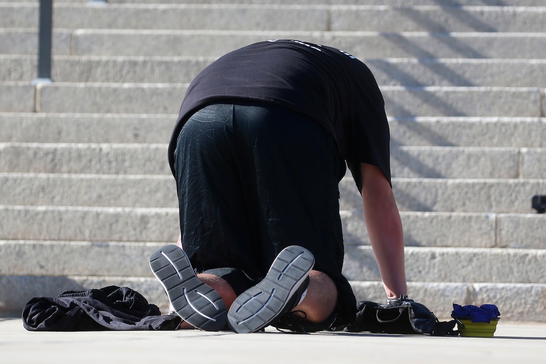 Shane Brooks, a Marine Corps veteran, kneels for nine hours outside the Utah Capitol to call attention to racial injustice, police brutality and mental health, Thursday, Aug. 6, 2020, in Salt Lake City. Brooks said people of color with mental illness are "looked at as if they have already committed a crime" and some end up dead in encounters with police, KTVX-TV reported. Brooks said his marathon silent protest was inspired by Bobby Duckworth, a 26-year-old who was shot and killed in 2019 by police responding to a report of a suicidal person in Wellington, Utah. (AP Photo/Rick Bowmer)