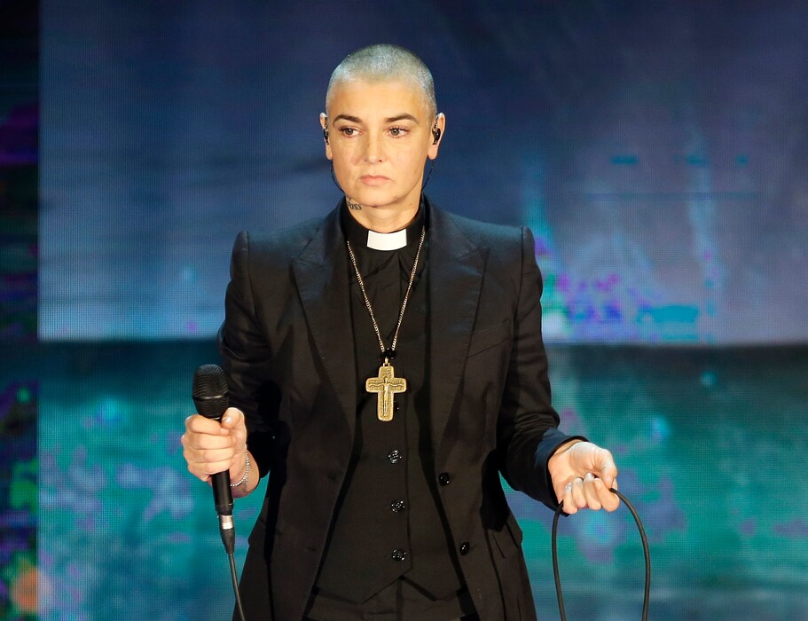 FILE - In this Oct. 5, 2014 file photo, Irish singer Sinead O'Connor performs during the Italian State RAI TV program "Che Tempo che Fa", in Milan, Italy. O'Connor emotionally pleaded for help and opened up about her struggles with mental illness in a Facebook video posted on Thursday, Aug. 3, 2017. A follow-up Facebook said to be made on O’Connor’s behalf late Monday said the singer was OK. (AP Photo/Antonio Calanni, File)