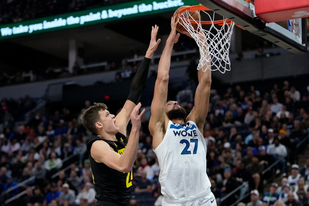 (Abbie Parr | AP) Minnesota Timberwolves center Rudy Gobert (27) shoots as Utah Jazz center Walker Kessler defends during the second half of an NBA basketball game Thursday, Nov. 30, 2023, in Minneapolis.