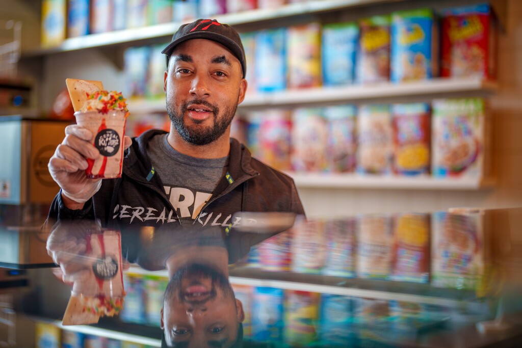(Trent Nelson  |  The Salt Lake Tribune) Chris Burns, owner of Cereal Killerz Kitchen in Salt Lake City, shows an ice cream treat with cereal and a Pop-Tart. Cereal restaurants are a growing trend in sweet treats in Utah.