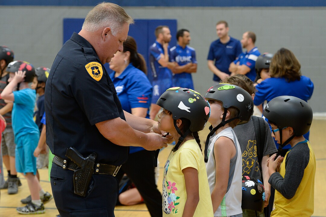 (Francisco Kjolseth  |  The Salt Lake Tribune)  In advance to the upcoming Tour of Utah bicycle race, more than 50 Salt Lake City-area kids receive a new bicycle helmet at the Capitol West Boys & Girls Club on Tuesday, July 31, 2018. As part of UnitedHealthcare's Pro Cycling team and community outreach program to keep kids healthy and active, team cyclists Jonny Clarke and Sebastian Haedo engage the kids in a few warm up routines before getting on the bike.