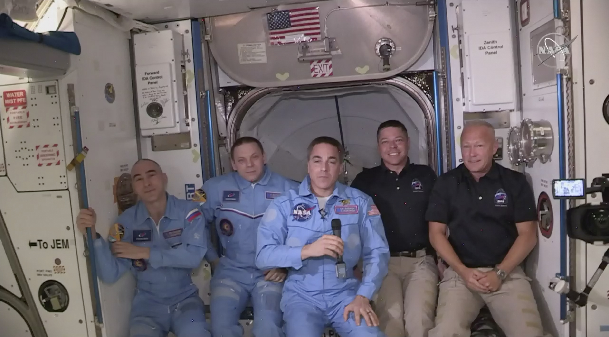 (NASA via AP)  Bob Behnken and Doug Hurley, far right, joining the the crew at the International Space Station, after the SpaceX Dragon capsule pulled up to the station and docked Sunday, May 31, 2020.  The Dragon capsule arrived Sunday morning, hours after a historic liftoff from Florida. It's the first time that a privately built and owned spacecraft has delivered a crew to the orbiting lab.