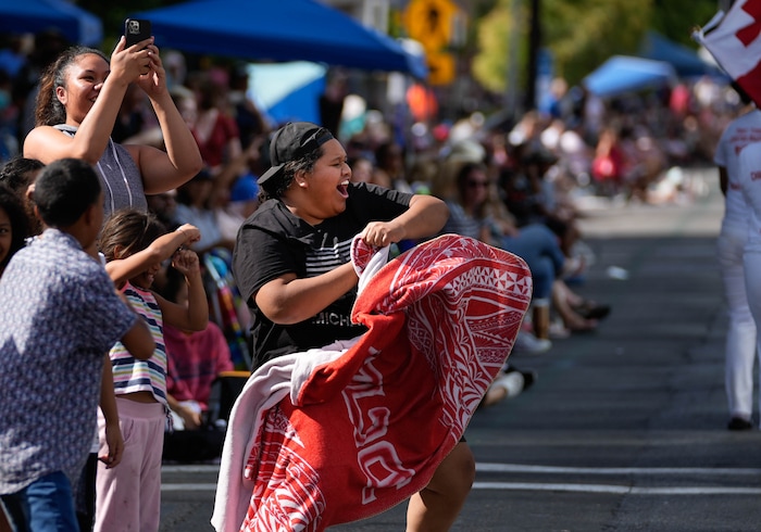 (Francisco Kjolseth | The Salt Lake Tribune) Faleule Matangi cheers on the First Tongan Christian Church participating in the Days of ’47 Parade in Salt Lake City on Saturday, July 23, 2022.