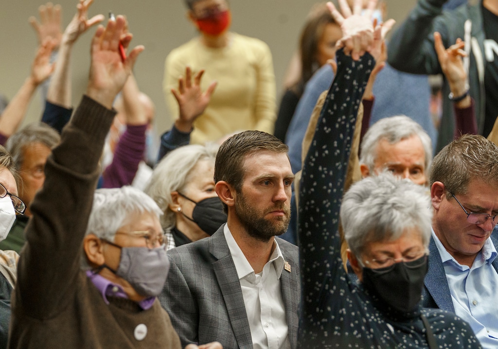 (Leah Hogsten | The Salt Lake Tribune) Carson Jorgensen, chairman of the Utah Republican Party, center, was surrounded by members of the public reacting in agreement to public comment by raising their hands in solidarity against the newly drawn redistricting maps in House Building, Room 30, Nov. 8, 2021.The public got to respond on Monday to the Utah Legislature’s Redistricting Committee's only public hearing for the map proposals.  
