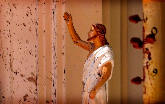 Blood stains are seen on the wall and on a Jesus Christ statue at the St. Sebastian's Church after blast in Negombo, north of Colombo, Sri Lanka, Sunday, April 21, 2019. More than two hundred people were killed and hundreds more injured in eight blasts that rocked churches and hotels in and just outside Sri Lanka's capital on Easter Sunday. (AP Photo)