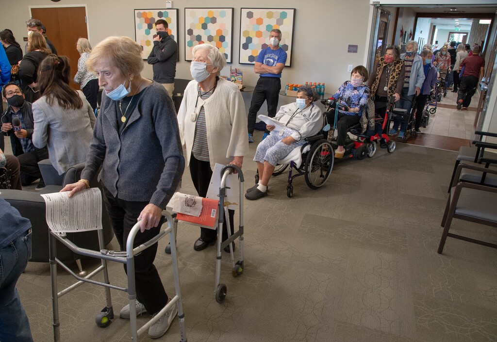 (Francisco Kjolseth  | The Salt Lake Tribune) Seniors and staff line up at The Ridge Foothill, an assisted living center in Salt Lake City, to receive the COVID-19 vaccine on Tuesday, Dec. 29, 2020, as the rollout continues at long-term care facilities.
