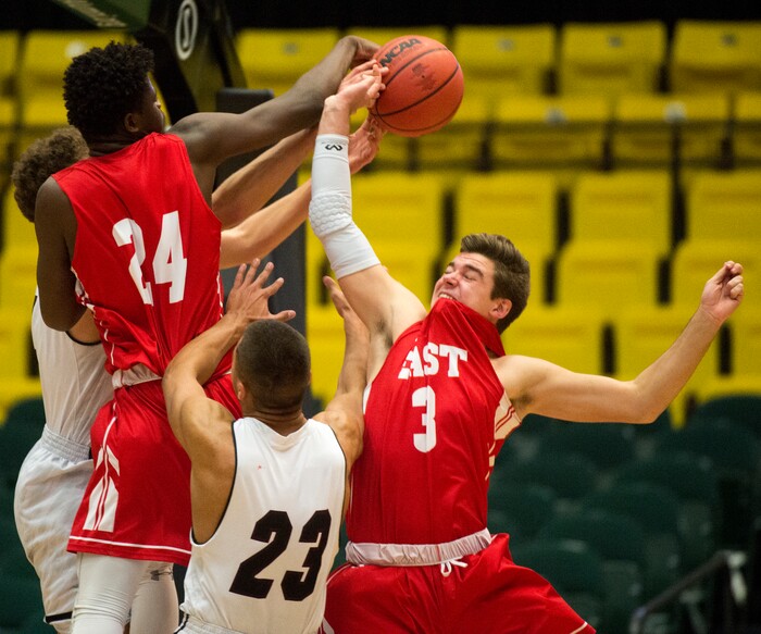(Rick Egan  |  The Salt Lake Tribune)  East Leopards Andre Mulibea (24) and East Leopards Ben Ford (3) go for a rebound, in 5A basketball playoff action between the East Leopards and the Jordan Beatdiggers at the UCCU Center in Orem, Monday, Feb. 26, 2018.