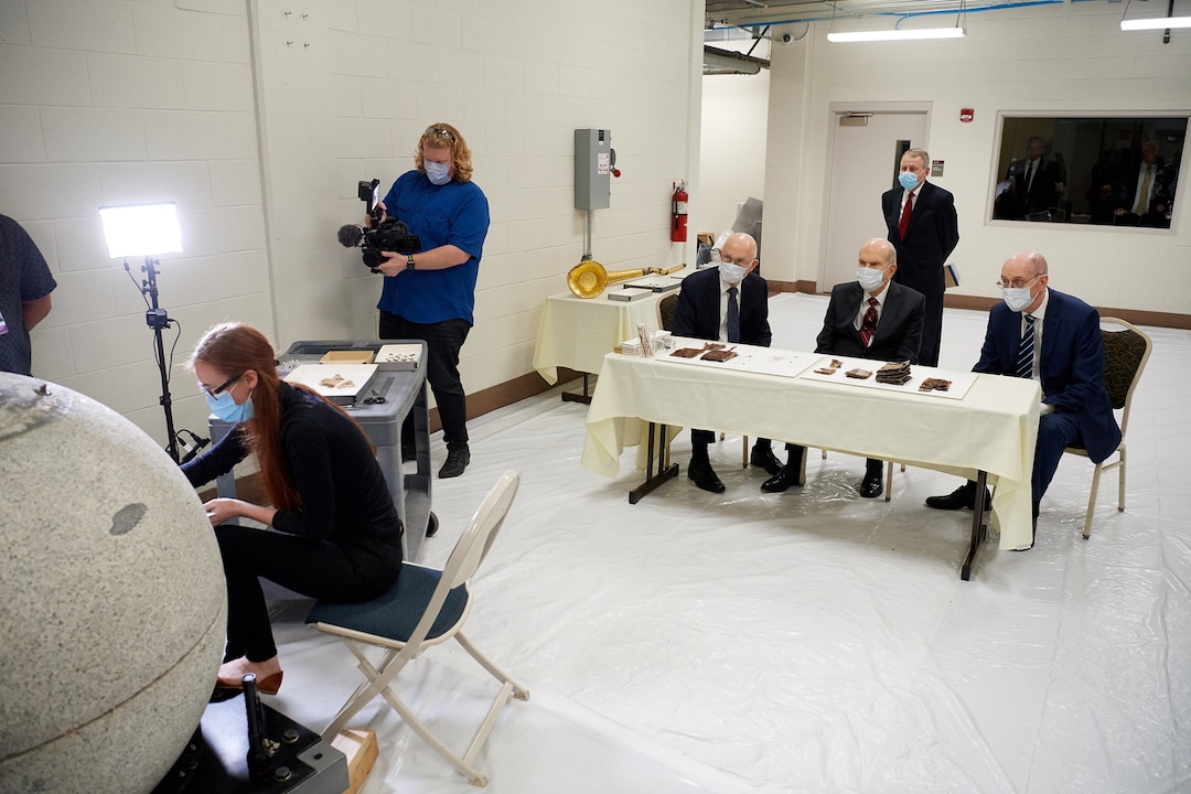 (Photo courtesy of The Church of Jesus Christ of Latter-day Saints) Emiline Twitchell, a conservator at the Church History Library, shows contents from the capstone of the Salt Lake Temple to the First Presidency on May 20, 2020.