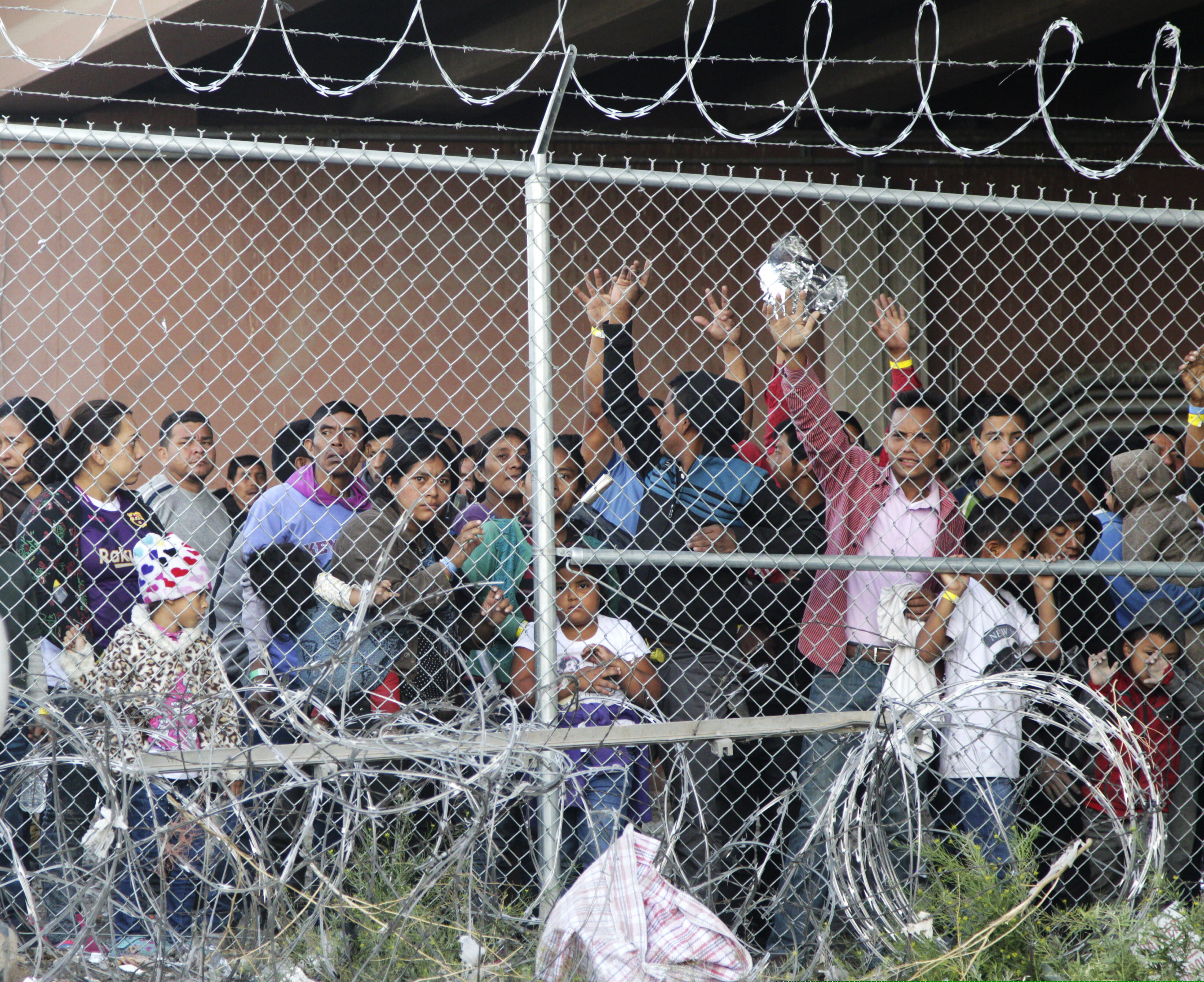 (Cedar Attanasio AP Photo) In this March 27, 2019 photo, Central American migrants wait for food in a pen erected by U.S. Customs and Border Protection to process a surge of migrant families and unaccompanied minors in El Paso, Texas. Texas Gov. Greg Abbott says he's sending another 1,000 National Guard troops to the U.S.-Mexico border and blasted Congress as a "group of reprobates" over the growing humanitarian crisis. Abbott said Friday, June 21, 2019, that the additional Guard members will assist at detention facilities and at ports of entry. .