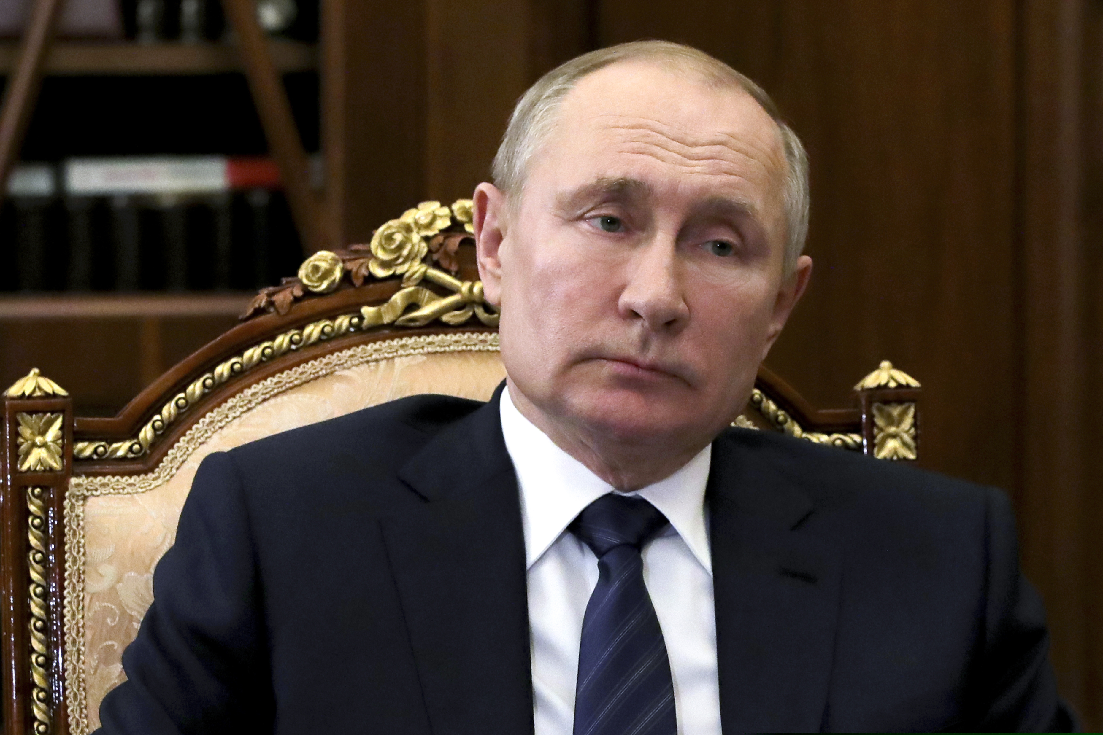 Russian President Vladimir Putin listens during a meeting in Moscow, Russia, Wednesday, Feb. 3, 2021. (Mikhail Klimentyev, Sputnik, Kremlin Pool Photo via AP)