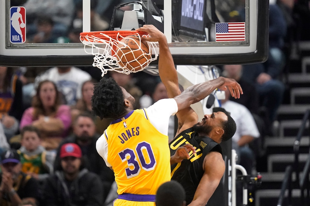 Utah Jazz guard Talen Horton-Tucker, right, dunks against Los Angeles Lakers center Damian Jones (30) during the second half of an NBA basketball game, Monday, Nov. 7, 2022, in Salt Lake City. (AP Photo/Rick Bowmer)