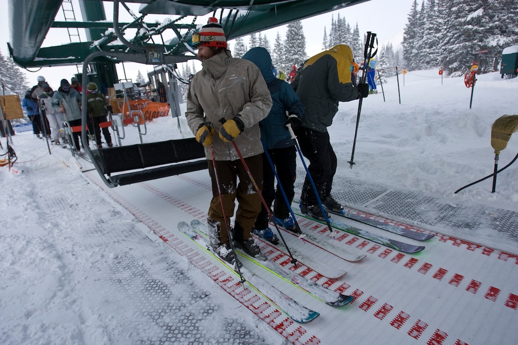 Chris Detrick | The Salt Lake Tribune
Skiers slide forward on a conveyor belt that eased loading onto the original Supreme chair lift at Alta Ski Area in 2008. The Supreme lift was combined with the Cecret lift in 2017 using an 8-degree bend. That caused "accelerated metal fatigue" in the lift and led to its upcoming realignment for the 2025-26 season.