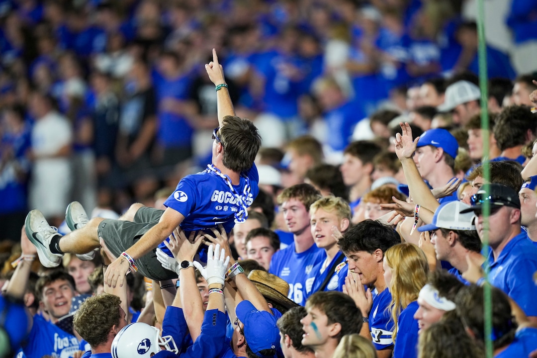 (Bethany Baker  |  The Salt Lake Tribune) BYU Cougars lift a fan up during the game between the BYU Cougars and the Iowa State Cyclones in Provo on Friday, Oct. 9, 2026.