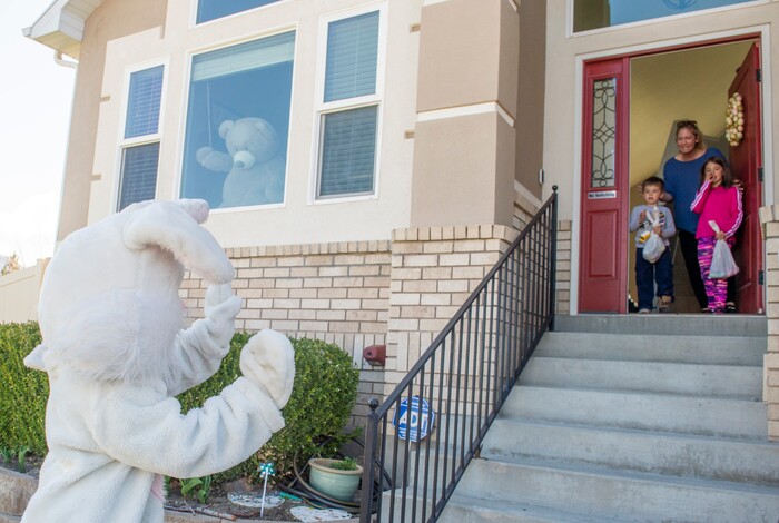 (Rick Egan  |  The Salt Lake Tribune)     Hannah, Noah, Suzanne Hogsed greet the Easter Bunny, from their front porch in Draper. Draper City Parks and Recreation workers along with the police and the fire department, delivered more than 30,000 Easter eggs to children at their doorsteps, Friday, April 10.