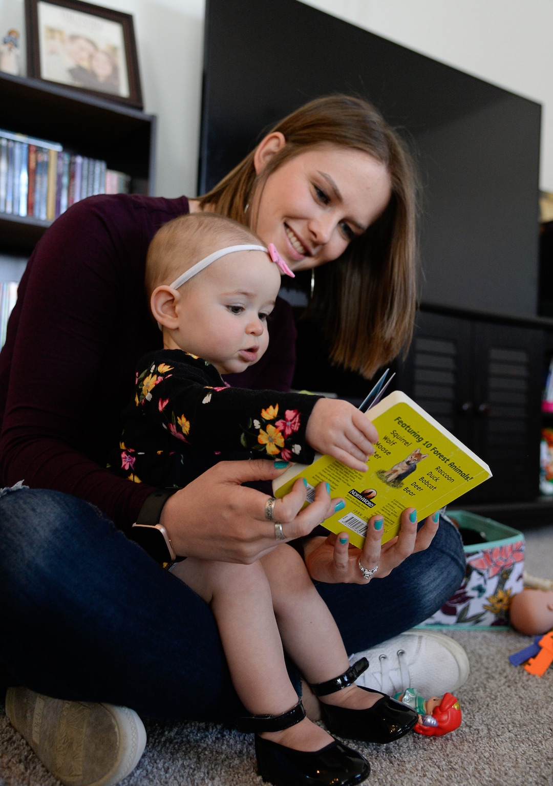 (Francisco Kjolseth  |  The Salt Lake Tribune)  Ember Ulrich reads with her daughter Jemma, 1, at their home in Lehi after moving there last October. Ember and her husband Jeremy started looking for a place where they could get more home for their money along with some friends who ended up moving in next door in Lehi. Jeremy was also looking for a place closer to his job at Adobe in Lehi 