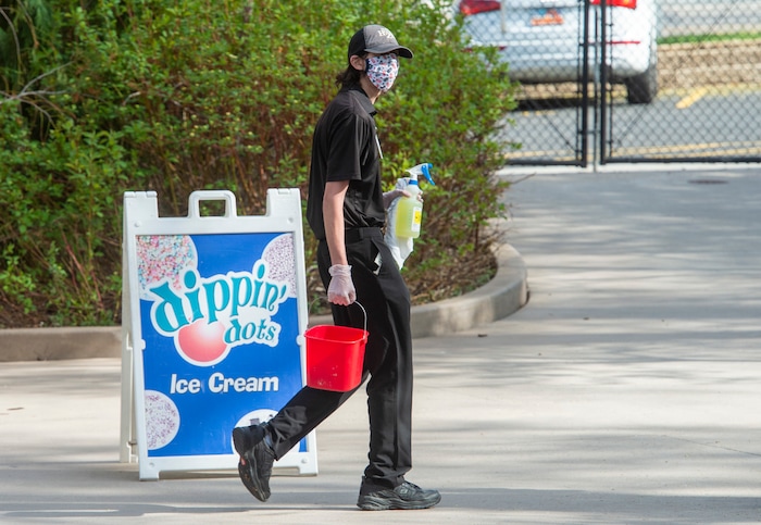 (Rick Egan  |  The Salt Lake Tribune)   A Hogle Zoo employee carries disinfectant  as the zoo opened up again for visitors, with special rules for social distancing, Saturday May 2, 2020