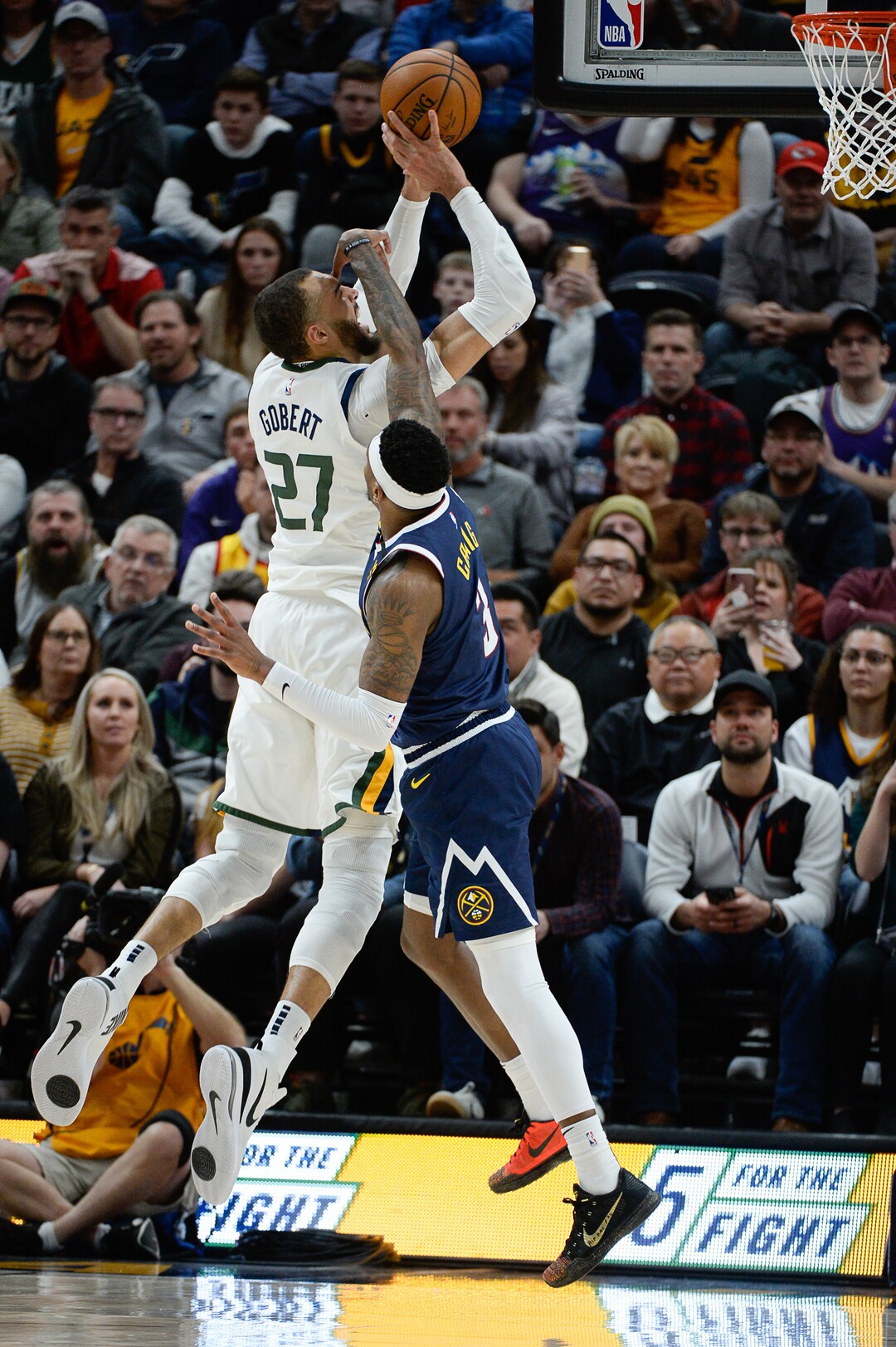 (Francisco Kjolseth  |  The Salt Lake Tribune) Utah Jazz center Rudy Gobert (27) gets hit in the face by Denver Nuggets forward Torrey Craig (3) as the Utah Jazz host the Denver Nuggets in their NBA basketball game at Vivint Smart Home Arena in Salt Lake City on Wednesday, Feb. 5, 2020.