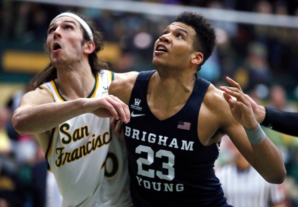 BYU forward Yoeli Childs (23) and San Francisco forward Matt McCarthy (10) look for a rebound during the second half of an NCAA college basketball game Saturday, Feb. 11, 2017, in San Francisco. (AP Photo/Tony Avelar)