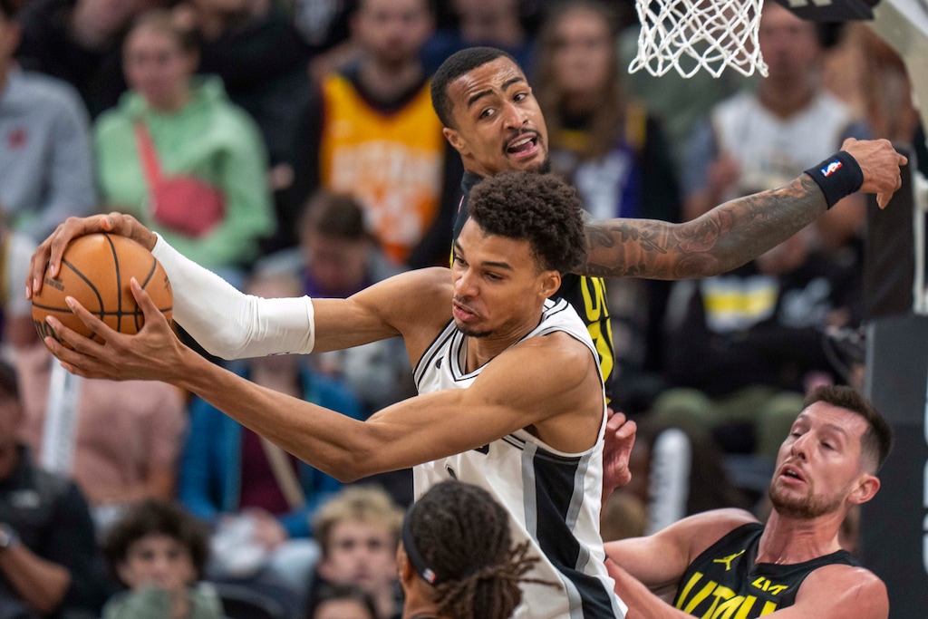 San Antonio Spurs center Victor Wembanyama (1) grabs a rebound from Utah Jazz forward John Collins (20) during the second half of an NBA basketball game, Thursday, Oct. 31, 2024, in Salt Lake City. (AP Photo/Rick Egan)