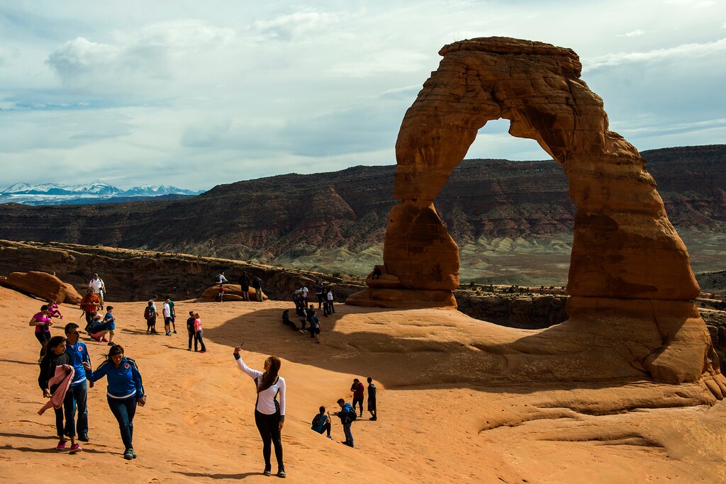 (Chris Detrick | The Salt Lake Tribune) Visitors take pictures and hike around Delicate Arch in Arches National Park Saturday, March 5, 2016.