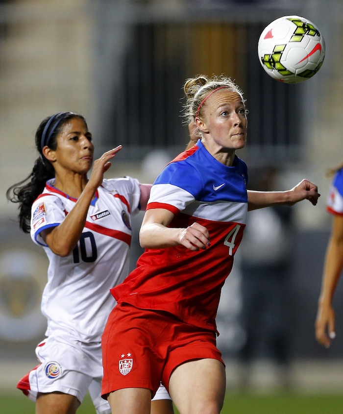 United States defender Becky Sauerbrunn (4) in action against Costa Rica midfielder Shirley Cruz (10) during the CONCACAF championship soccer match in Chester, Pa., Sunday, Oct. 26, 2014. The United States defeated Costa Rica 6-0. (AP Photo/Rich Schultz)
