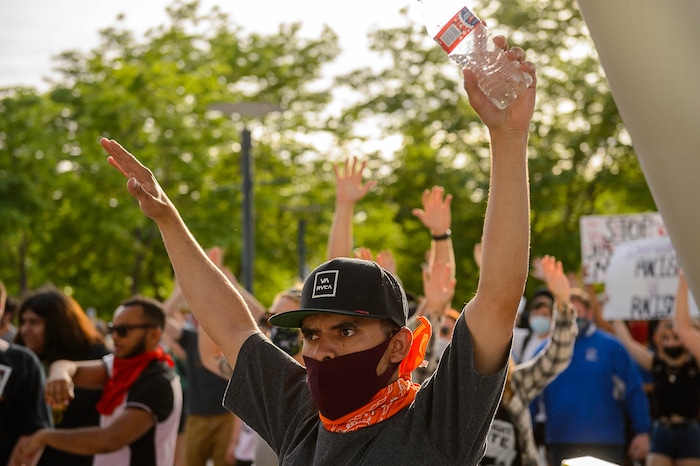 (Trent Nelson  |  The Salt Lake Tribune) People raising their hands in front of the Public Safety Building during a protest against police brutality in Salt Lake City on Monday, June 1, 2020.