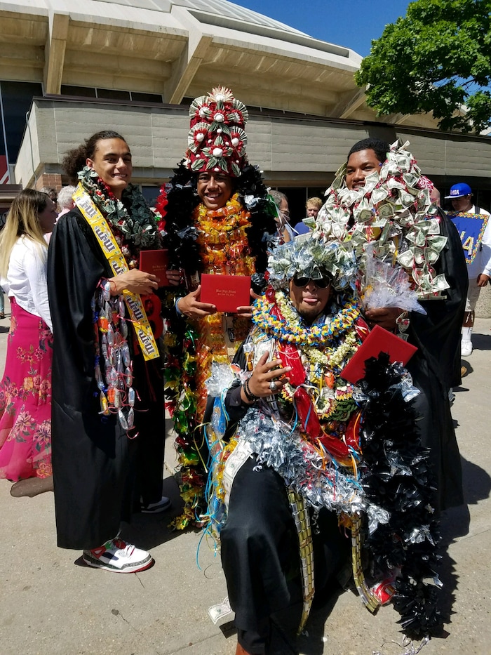 (Courtesy of Claustina Mahon-Reynolds) High school students in Salt Lake City School District wear bundles of leis after graduation this year. The flower necklaces were banned from the floor during the ceremonies at the Huntsman Center. Pacific Islander students, when allowed, typically wear one or two fresh leis during their graduation to honor their heritage. Relatives then pile more on after the ceremony, in celebration.