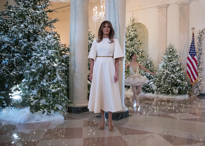First lady Melania Trump pauses as a ballerina performs a piece from The Nutcracker behind her among the 2017 holiday decorations in the Grand Foyer of the White House in Washington, Monday, Nov. 27, 2017. The First Lady honored 200 years of holiday traditions at the White House. (AP Photo/Carolyn Kaster)