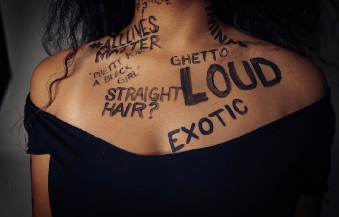 (Photo courtesy of Ana Brown Photo + Film) Stephanie Nguyen Lake covered in painted words of negative stereotypes used to belittle black women.
