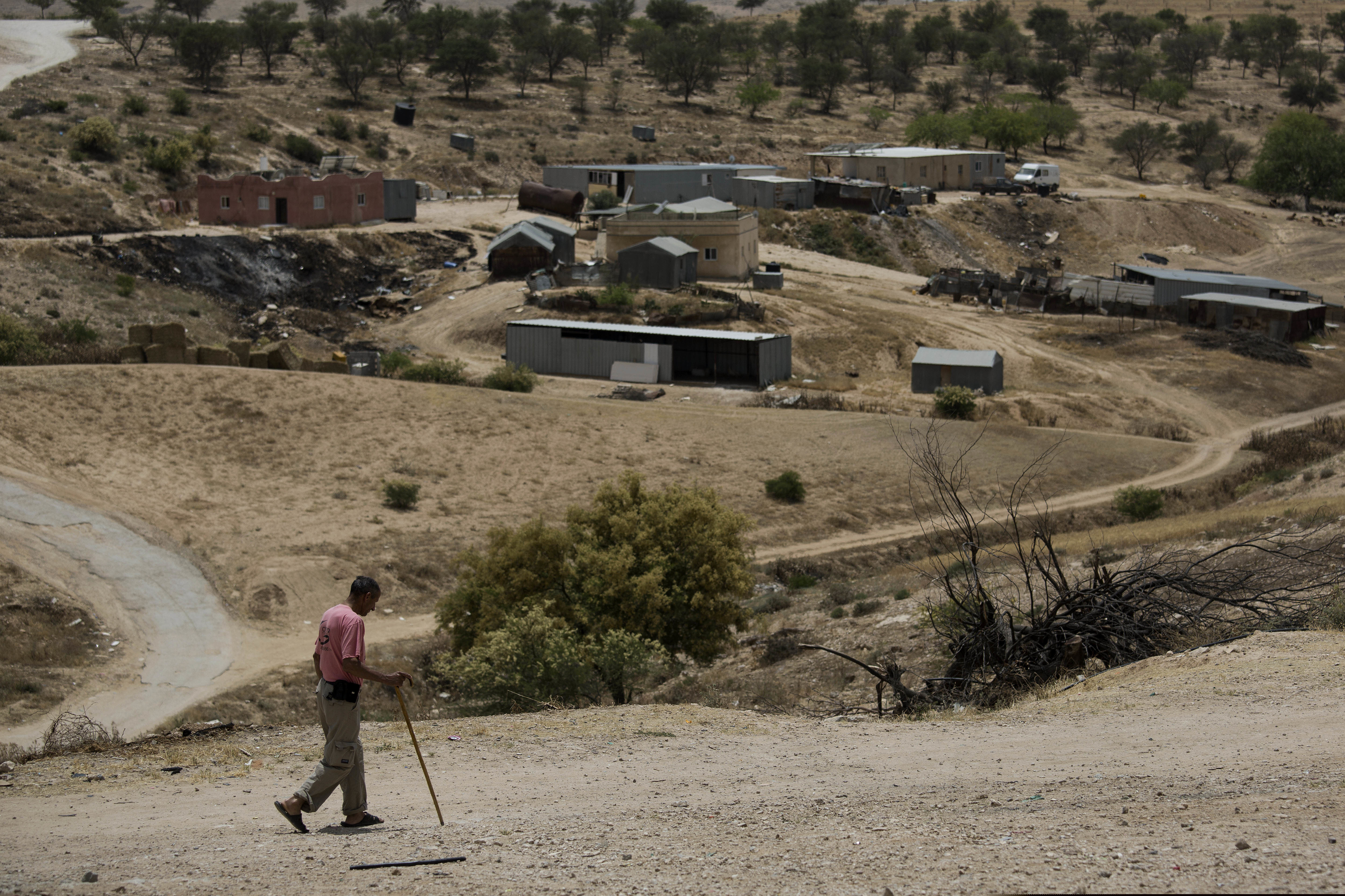 (Tsafrir Abayov  |  AP file photo)  In this May 12, 2015 file photo, a Bedouin man walks through the village of Umm Al-Hiran in the Israeli Negev desert. Israel has begun cracking down on polygamy among the country’s Bedouins, after decades of turning a blind eye to the old custom that remains widespread in the community. But many Bedouins, complaining of systematic neglect and discrimination by Israeli governments, see only a ploy to curb their population growth and criminalize their community members.