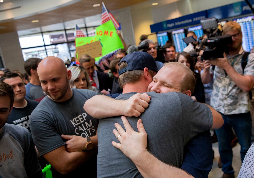 Josh Holt, right, is greeted by family and friends upon returning to Salt Lake City after receiving medical care and visiting President Donald Trump in Washington on Monday, May 28, 2018. Holt was freed this weekend after being held in a Venezuelan jail for nearly two years. (AP Photo/Kim Raff)