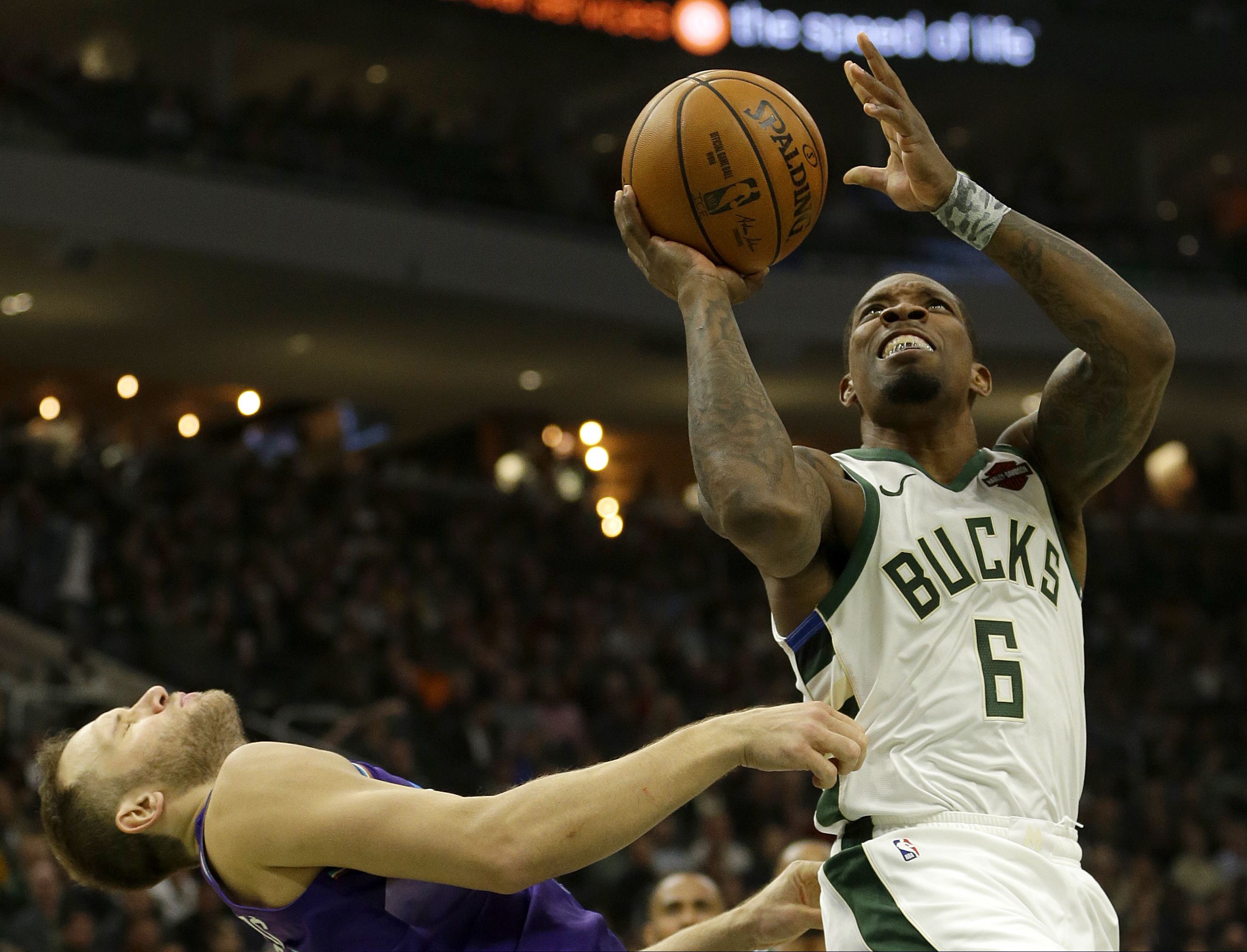 Milwaukee Bucks' Eric Bledsoe (6) commits an offensive foul against Utah Jazz's Bojan Bogdanovic during the first half of an NBA basketball game Monday, Nov. 25, 2019, in Milwaukee. (AP Photo/Aaron Gash)