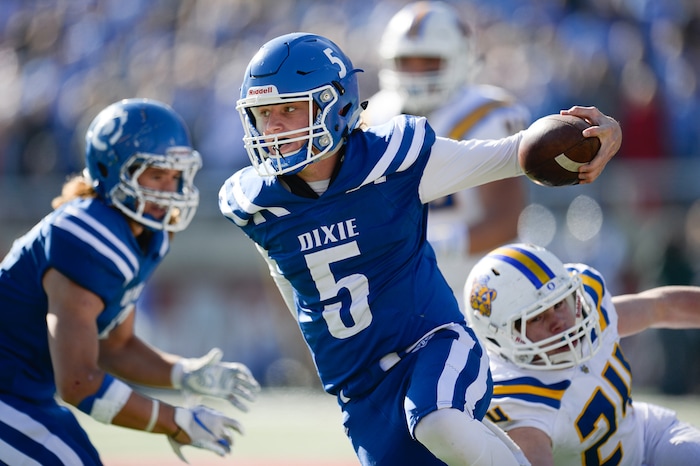 (Francisco Kjolseth  |  The Salt Lake Tribune)  Dixie quarterback Reggie Graff tries to get clear against Orem in the 4A high school championship game at Rice Eccles Stadium in Salt Lake City, Friday, Nov. 16, 2018.