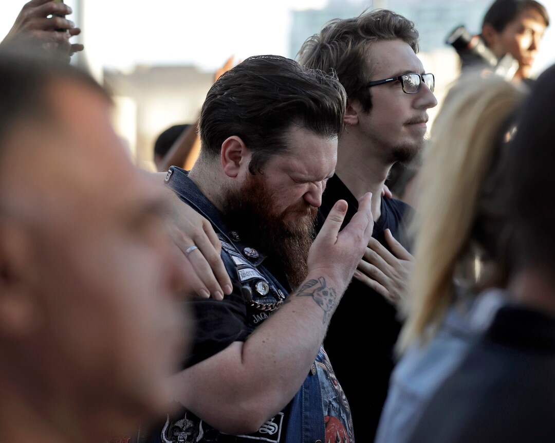 (Gregory Bull  |  AP Photo)  Sean Bolger is comforted by a friend during a vigil at City Hall in Las Vegas, Monday, Oct. 2, 2017. The vigil was held in honor of the over 50 people killed and hundreds injured in a mass shooting at an outdoor music concert late Sunday.
