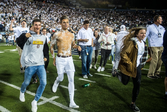 (Chris Detrick  |  The Salt Lake Tribune)  Utah State Aggies students run onto the field after the game at Merlin Olsen Field at Maverik Stadium Friday, September 29, 2017. Utah State Aggies defeated Brigham Young Cougars 40-24.