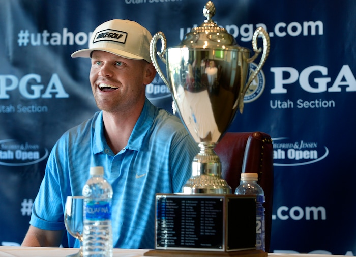 (Scott Sommerdorf | The Salt Lake Tribune)
Patrick Fishburn relaxes with his trophy after winning the Utah Open golf tournament played at the Riverside Country Club, Sunday, August 27, 2017.