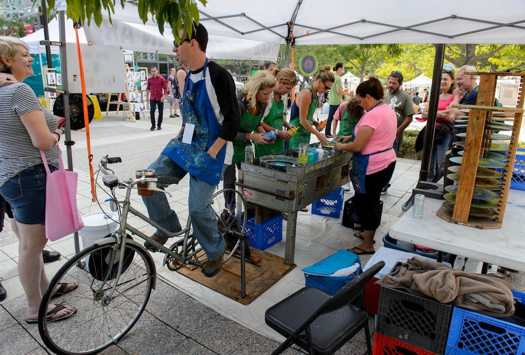 (Steve Griffin  |  The Salt Lake Tribune) People use liquid paints as they make spin art during the Urban Arts Festival at the Gallivan Center in Salt Lake City Sunday September 17, 2017. The two day festival featured artists, music, dance performance, automotive arts, projection art, virtual reality and new media arts.