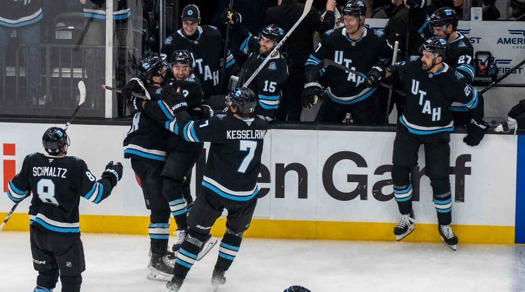(Rick Egan | The Salt Lake Tribune)  Utah Hockey Club center Clayton Keller (9) jumps on Utah Hockey Club defenseman Mikhail Sergachev (98) to celebrate Sergachev's game-winning goal in overtime, giving Utah a 3-2 win over the Vancouver Canucks at the Delta Center, on Wednesday, Dec 18, 2024.