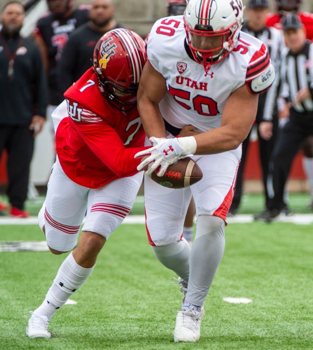 (Rick Egan  |  The Salt Lake Tribune)  Quarterback Cameraon Rising, (7) attempts to wrestle the ball back, after offensive lineman, Orlando Umana pickup his fumble, for a receiver, in Utah's spring Red-White game at Rice-Eccles Stadium, Saturday, April 13, 2019.