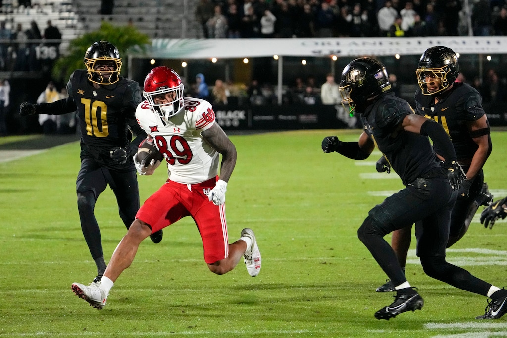 Utah wide receiver Zacharyus Williams (89) looks for running room after a reception against the Central Florida defense including defensive back Quadric Bullard (10) during the first half of an NCAA college football game, Friday, Nov. 29, 2024, in Orlando, Fla. (AP Photo/John Raoux)