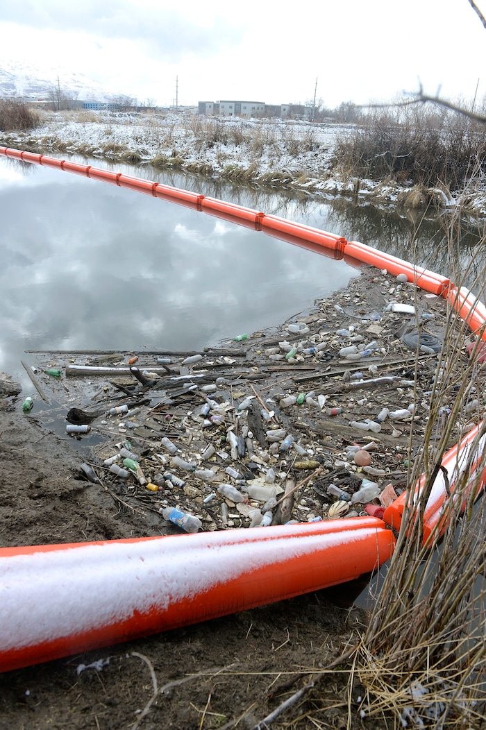 (Al Hartmann | The Salt Lake Tribune)
Booms along the Jordan RIver at about 1700 West and Center Street in North Salt Lake are collecting trash, especially plastic that makes its way down the Jordan River and into the Great Salt Lake where it kills birds. The Natiure Conservency worked with Salt Lake County and private landowners to install the trash-catching booms. They can then be manually cleaned before it reaches the lake.