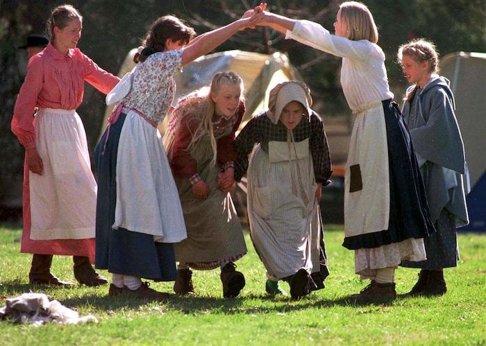 Rick Egan  | Tribune File Photo 

L-R Jennifer Dicken, Rebekah Herterich, Emily Dicken, Adriana Herterich, and Christina Dicken, pass the time Saturday morning by doing some old pioneer dances, in Florence, Nebraska. 