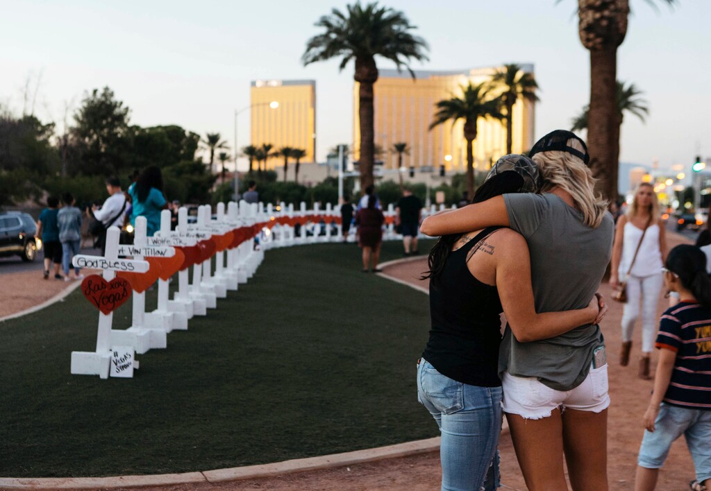 A memorial displaying 58 crosses by Greg Zanis stands at the Welcome To Las Vegas Sign on Thursday, October 5, 2017, in Las Vegas. Each cross has the name of a victim killed during the mass shooting at the Route 91 Harvest country music festival this past Sunday. Dozens of people were killed and hundreds were injured.  (Mikayla Whitmore/Las Vegas Sun via AP)
