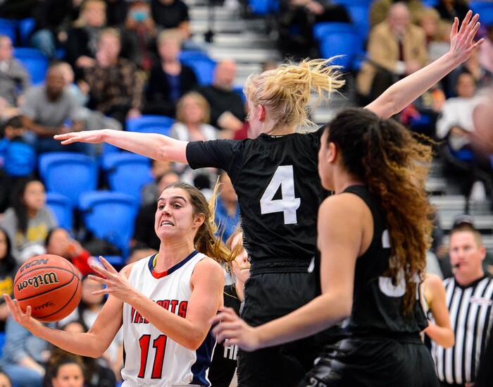 (Trent Nelson | The Salt Lake Tribune)  Woods Cross's Olivia Barton (11) defended by Highland's Olivia Beckstead (4) as Woods Cross faces Highland in the 5A High School Girls' Basketball Tournament at SLCC in Taylorsville, Wednesday Feb. 21, 2018.