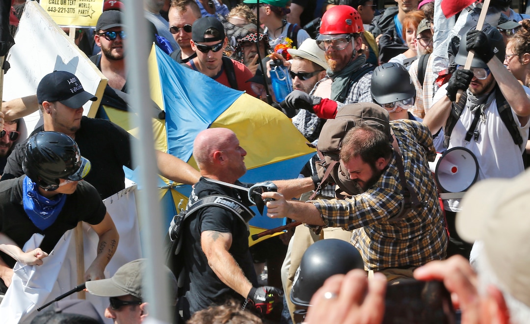 (Steve Helber  |  AP Photo)  White nationalist demonstrators clash with counter demonstrators at the entrance to Lee Park in Charlottesville, Va., Saturday, Aug. 12, 2017.  Gov. Terry McAuliffe declared a state of emergency and police dressed in riot gear ordered people to disperse after chaotic violent clashes between white nationalists and counter protestors.